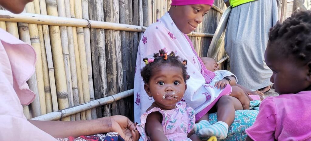 Uma mãe alimentando seu bebê com uma refeição que salva vidas no Distrito de Mecufi, Província de Cabo Delgado, Moçambique.