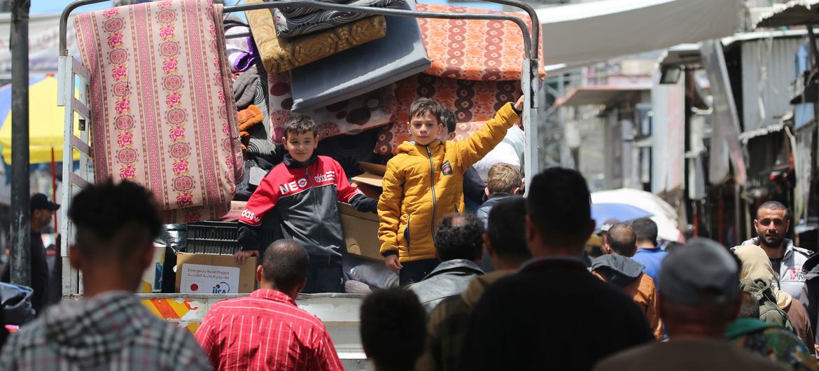 Duas crianças na traseira de um caminhão fugindo com a família de Rafah, no sul da Faixa de Gaza