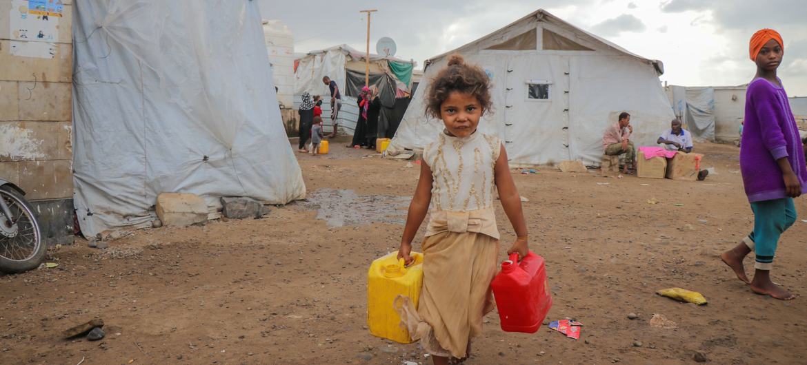 Uma criança busca água potável em um acampamento para deslocados em Dar Saad, no Iêmen